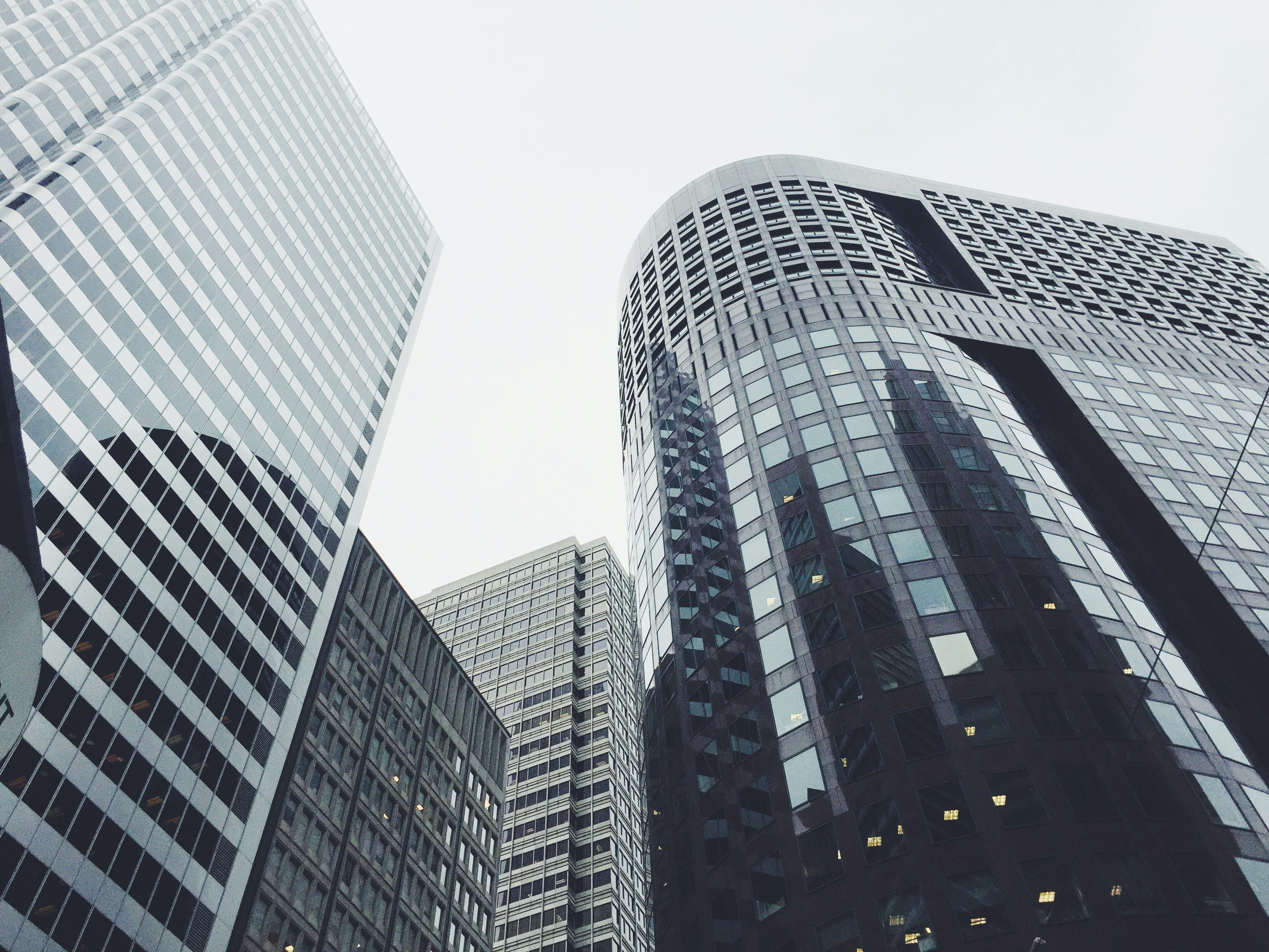 low-angle photography of glass window buildings